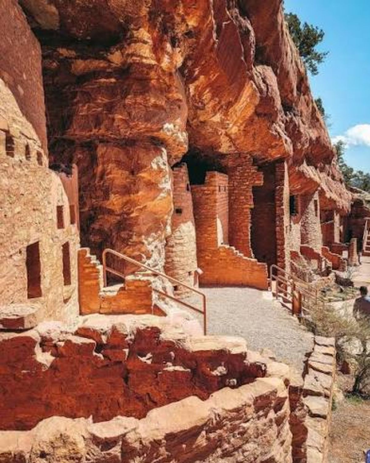 The Manitou Cliff Dwellings: stone rooms and doorways built into a red sandstone overhang