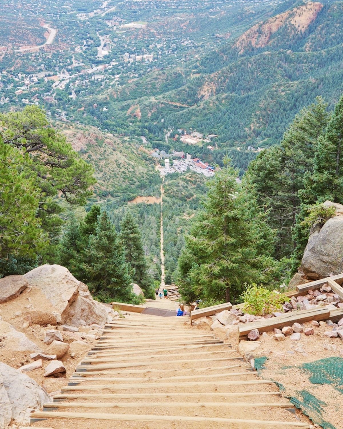 The Manitou Incline seen from across the valley, its line of railroad-tie steps running straight up the forested mountainside