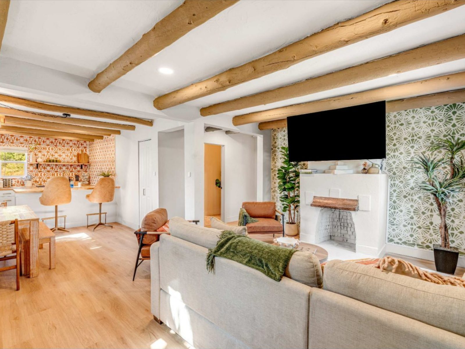 Three bedroom casita with living room, fireplace, dining table and kitchen bar