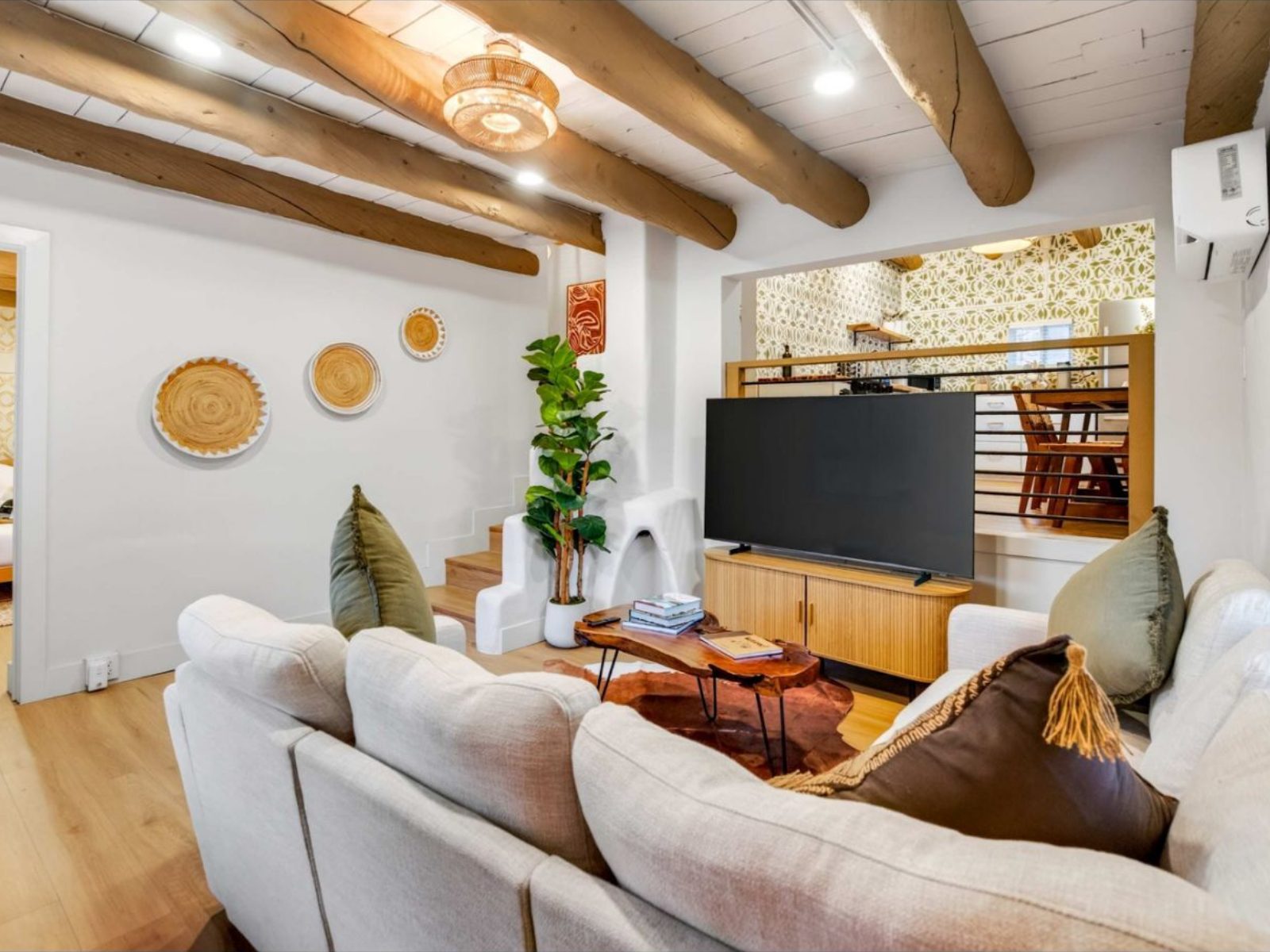 Two bedroom casita living room with a corner sofa and steps up to the kitchen
